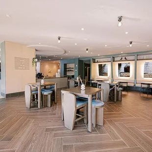 a dining area with tables and chairs
