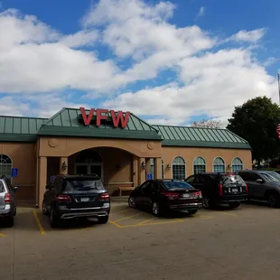 a parking lot with cars parked in front of it