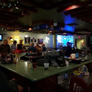 a group of people sitting at a bar