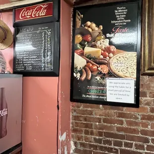 a brick wall and a menu board