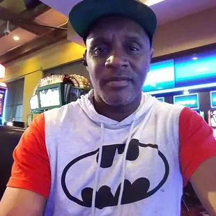 a man wearing a batman t - shirt