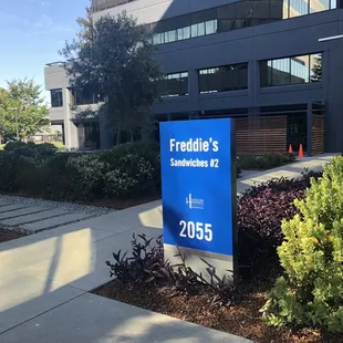 a sign in front of a building