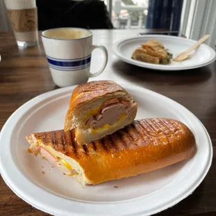 Turkey panini with American cheese and tomato. Spanakopita and an iced chai in the back.