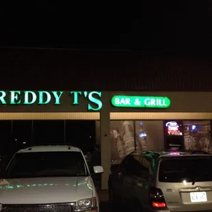 two cars parked in front of the restaurant