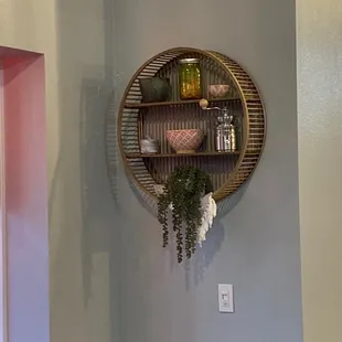 a round bamboo shelf with plants