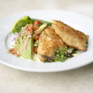 A Parmesan Crusted Red Snapper served on citris buer blanc and pesto basil sauce