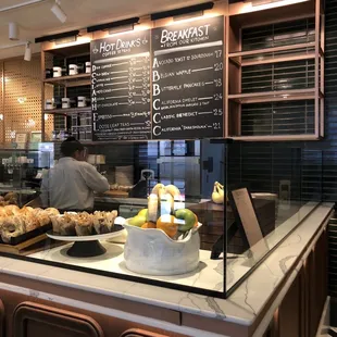 a bakery counter with a variety of pastries