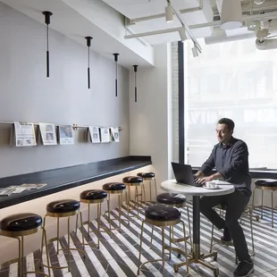 a man sitting at a table with a laptop