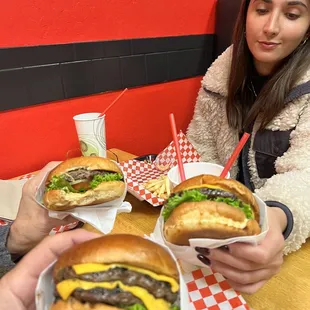 a man and a woman eating hamburgers