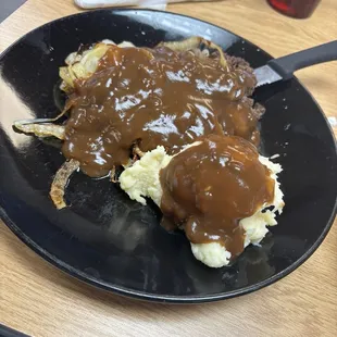 Hamburger steak w/ onions and mashed potatoes and gravy