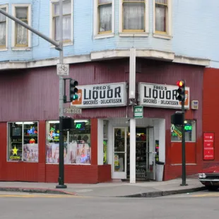 a red car parked in front of the store