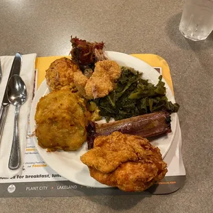 a plate of fried chicken and greens