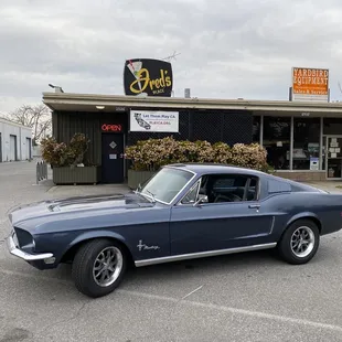 a classic mustang in a parking lot