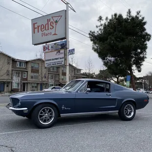 a classic mustang in a parking lot