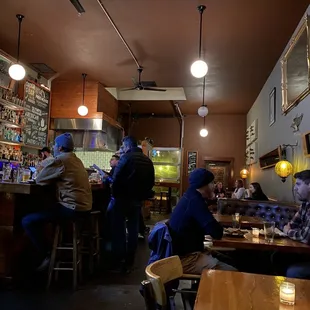 a group of people sitting at a bar