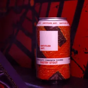 a can of beer sitting on a bench