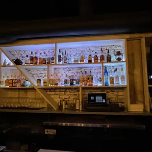 a bar with shelves full of liquor bottles