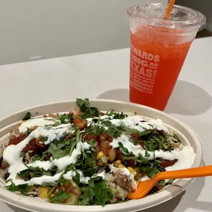 a bowl of salad and a drink