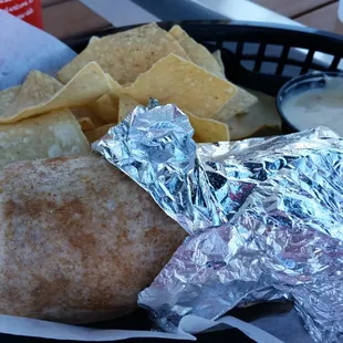 Hybird chicken burrito on wheat with add on drink and chips and queso.