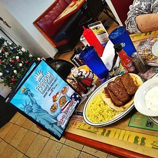 a woman sitting at a table with food