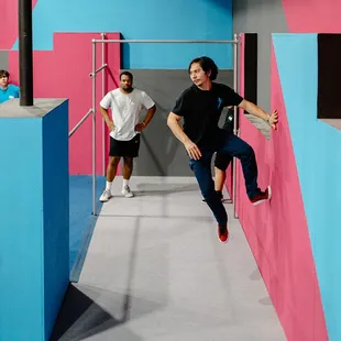 Adults bouncing off the walls in their parkour lesson