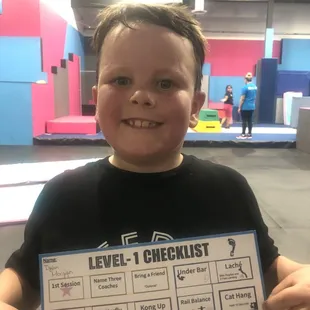 My son showing me his checklist after class