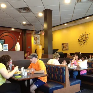 people sitting at tables in a restaurant