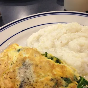 Spinach, mushroom &amp; provolone omelette with grits on the side.