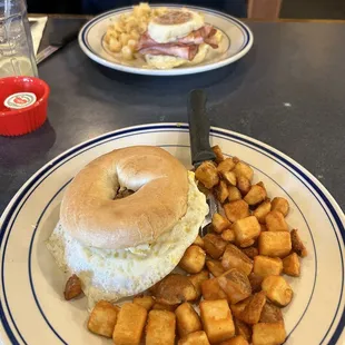 a bagel sandwich and hash browns
