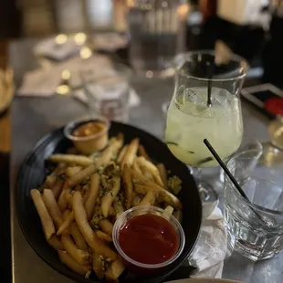 a plate of french fries and a drink