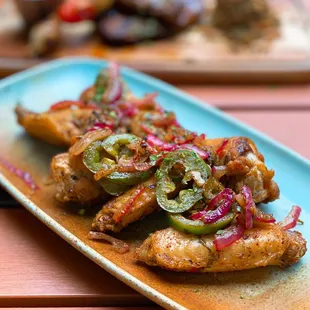 Jawaneh: Mediterranean seasoned chicken wings sautéed w/ onions, jalapeños peppers | $14