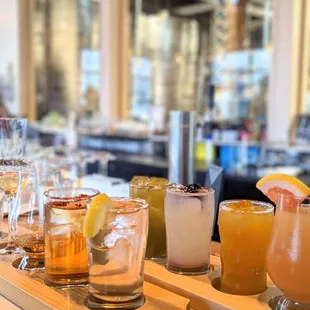 a variety of cocktails on a bar