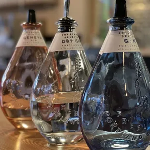 three bottles of alcohol on a table