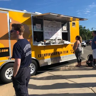 a man standing in front of a food truck