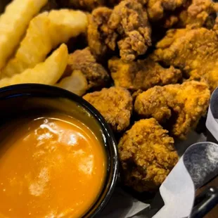a basket of fried chicken and fries