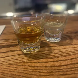 two glasses of whiskey on a table