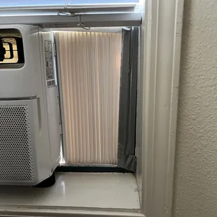 Portable air conditioning unit in first floor window