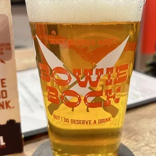 a glass of beer on a coaster