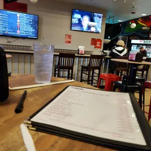 a menu on a table in a bar