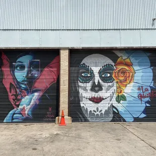 a garage door with a mural of a skull and roses