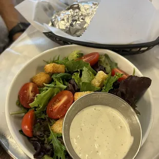 a plate of salad with dressing