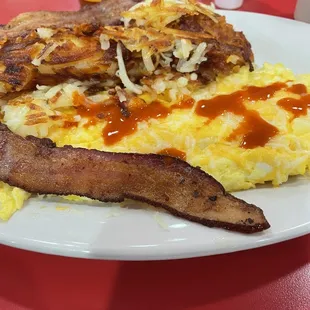 Scrambled eggs bacon and hash browns