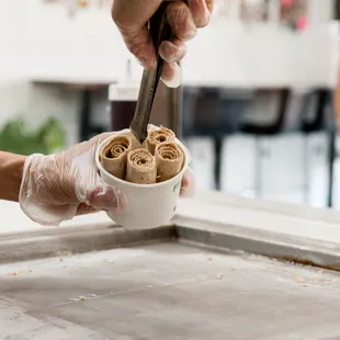 a person holding a scoop of ice cream