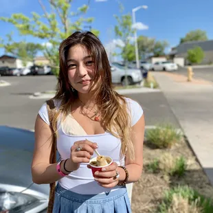  a woman holding a cup of ice cream