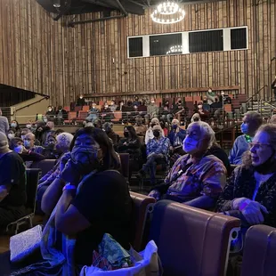 a large group of people sitting in chairs