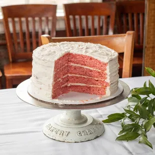 a red velvet cake with a slice taken out of it