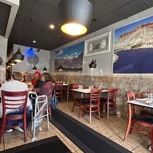 people sitting at tables in a restaurant