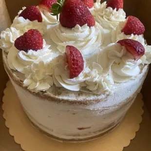 Vanilla cake with strawberries &amp; homemade whipped cream topping.