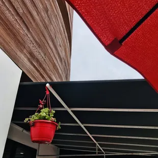 a patio with red umbrellas and tables