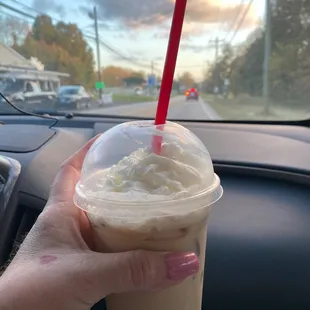 a hand holding a cup of coffee